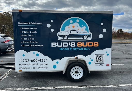 Bud’s Suds Mobile Detailing trailer parked in Ocean County NJ, showcasing exterior and interior detailing, paint decon, steam cleaning, and contact information.